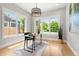 Bright home office featuring large windows, modern light fixture, and a comfortable workspace at 1500 S Elizabeth St, Denver, CO 80210