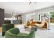 Open living room with a view of the kitchen, modern furniture, and access to the outdoors at 1500 S Elizabeth St, Denver, CO 80210