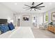 Spacious main bedroom features neutral tones, a ceiling fan, and a sitting area by the window at 1500 S Elizabeth St, Denver, CO 80210