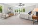 Bright main bedroom featuring a ceiling fan, large windows, and stylish decor at 1500 S Elizabeth St, Denver, CO 80210
