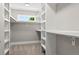 Walk-in closet featuring custom shelving and ample storage space at 1500 S Elizabeth St, Denver, CO 80210