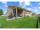 Cozy backyard patio with grill and outdoor seating overlooks a lush lawn and beautiful landscaping at 5230 Periwinkle Way, Henderson, CO 80640