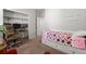 Comfortable bedroom with neutral colors, featuring a cozy bed and desk area at 5230 Periwinkle Way, Henderson, CO 80640