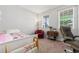 Bright bedroom featuring a white bed frame, large windows, and ample natural light at 5230 Periwinkle Way, Henderson, CO 80640