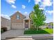 Charming two-story home with a well-manicured front yard and inviting curb appeal at 5230 Periwinkle Way, Henderson, CO 80640
