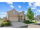 Inviting two-story home with a manicured lawn, attractive landscaping, and a welcoming facade at 5230 Periwinkle Way, Henderson, CO 80640