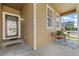 Cozy covered front porch with charming seating area, perfect for relaxation and enjoying the outdoors at 5230 Periwinkle Way, Henderson, CO 80640
