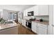 Well-equipped kitchen with white cabinets, granite countertops, and stainless steel appliances at 5230 Periwinkle Way, Henderson, CO 80640