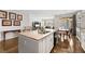 Open kitchen with granite countertops and a view into the living and dining areas at 5230 Periwinkle Way, Henderson, CO 80640