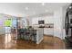 Modern kitchen with white cabinets, granite countertops, and a breakfast bar for casual dining at 5230 Periwinkle Way, Henderson, CO 80640