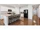 Spacious kitchen features a large island with granite countertops at 5230 Periwinkle Way, Henderson, CO 80640