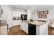 Bright kitchen features white cabinets, granite countertops, and stainless steel appliances at 5230 Periwinkle Way, Henderson, CO 80640