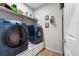 Convenient laundry room equipped with modern washer and dryer, and ample storage space at 5230 Periwinkle Way, Henderson, CO 80640