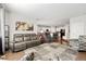 Spacious living room connected to the kitchen and dining areas at 5230 Periwinkle Way, Henderson, CO 80640