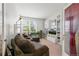 Bright and airy living room featuring comfortable seating, bookshelves, and a large window at 5230 Periwinkle Way, Henderson, CO 80640