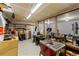 Workshop with workbench, tools, and a large window for natural light at 5230 Periwinkle Way, Henderson, CO 80640