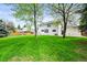 Spacious backyard with lush green lawn and mature trees providing shade and privacy for outdoor enjoyment at 5853 S Havana Ct, Englewood, CO 80111