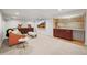 Finished basement featuring a wet bar, seating, and mounted television at 5853 S Havana Ct, Englewood, CO 80111