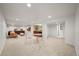 Spacious basement with carpet, recessed lights, wet bar, seating, and entertainment area at 5853 S Havana Ct, Englewood, CO 80111