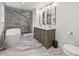 Luxurious bathroom with marble floors, standalone tub, glass shower, and double vanity at 5853 S Havana Ct, Englewood, CO 80111