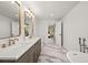 Elegant bathroom with double vanity, marble floors, standalone tub and ample space at 5853 S Havana Ct, Englewood, CO 80111