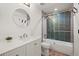 Stylish bathroom with white vanity, marble countertop, tub, and a tiled shower at 5853 S Havana Ct, Englewood, CO 80111