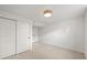 This empty bedroom has neutral walls, carpet, and lighting and includes a closet at 5853 S Havana Ct, Englewood, CO 80111