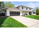 Charming home exterior with a large garage, well-maintained lawn, and inviting curb appeal in a great neighborhood at 5853 S Havana Ct, Englewood, CO 80111