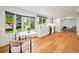 Cozy kitchen featuring stainless appliances, white cabinets, and an adjacent breakfast nook with backyard views at 5853 S Havana Ct, Englewood, CO 80111