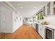 Expansive kitchen features hardwood floors, stainless appliances, and seamless flow to dining area at 5853 S Havana Ct, Englewood, CO 80111