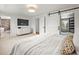 Bright main bedroom with ensuite bathroom, large TV and comfortable bed at 5853 S Havana Ct, Englewood, CO 80111