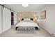 Beautiful main bedroom with patterned wallpaper, bench, and plush carpet at 5853 S Havana Ct, Englewood, CO 80111