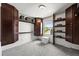 Bright walk-in closet with carpet, custom storage, and a window view at 5853 S Havana Ct, Englewood, CO 80111
