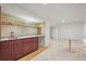 Finished basement with a modern wet bar, featuring stylish brick backsplash and wood shelving at 5853 S Havana Ct, Englewood, CO 80111