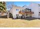Exterior view of home with a raised wood deck and brick paved patio in the yard at 4505 S Yosemite St # 106, Denver, CO 80237
