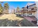 Exterior view of home with a raised wood deck and brick paved patio in the yard at 4505 S Yosemite St # 106, Denver, CO 80237
