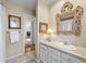 Charming bathroom features a framed mirror, vanity with sink, and adjacent hallway at 4505 S Yosemite St # 106, Denver, CO 80237
