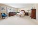 Spacious bedroom showcases natural light, wooden furniture, and neutral carpeting at 4505 S Yosemite St # 106, Denver, CO 80237
