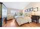 Bright bedroom showcases hardwood floors, a sitting area, and an elegant accent cabinet at 4505 S Yosemite St # 106, Denver, CO 80237