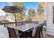 Outdoor deck featuring a dining area with shade under mature tree foliage at 4505 S Yosemite St # 106, Denver, CO 80237