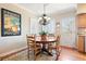 Dining room offers natural light from shuttered windows and a vintage Chicago poster at 4505 S Yosemite St # 106, Denver, CO 80237