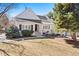 Charming white two-story home with manicured lawn and mature trees on a sunny day at 4505 S Yosemite St # 106, Denver, CO 80237