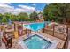 Relax in the hot tub next to the community pool with a wooden deck and lush green trees surrounding it at 4505 S Yosemite St # 106, Denver, CO 80237