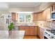 Lovely kitchen with hardwood floors, stone countertops, and stainless steel appliances at 4505 S Yosemite St # 106, Denver, CO 80237