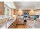 Bright kitchen with granite countertops, stainless steel appliances, and natural wood cabinetry at 4505 S Yosemite St # 106, Denver, CO 80237