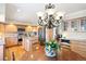 Bright kitchen features wooden cabinets, stainless steel appliances, and a decorative chandelier above an island at 4505 S Yosemite St # 106, Denver, CO 80237