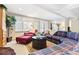 Inviting living room with a comfortable plaid sofa and bright natural light at 4505 S Yosemite St # 106, Denver, CO 80237