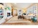 Bright living room featuring a fireplace, built-in shelving, and comfortable seating arrangement at 4505 S Yosemite St # 106, Denver, CO 80237