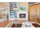 Inviting living room with a fireplace, hardwood floors, and a view to the entry at 4505 S Yosemite St # 106, Denver, CO 80237