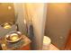 Updated bathroom with a vessel sink, granite countertop, and round mirror at 9274 Sandy Ln, Conifer, CO 80433